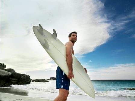 Man standing with surfboard
